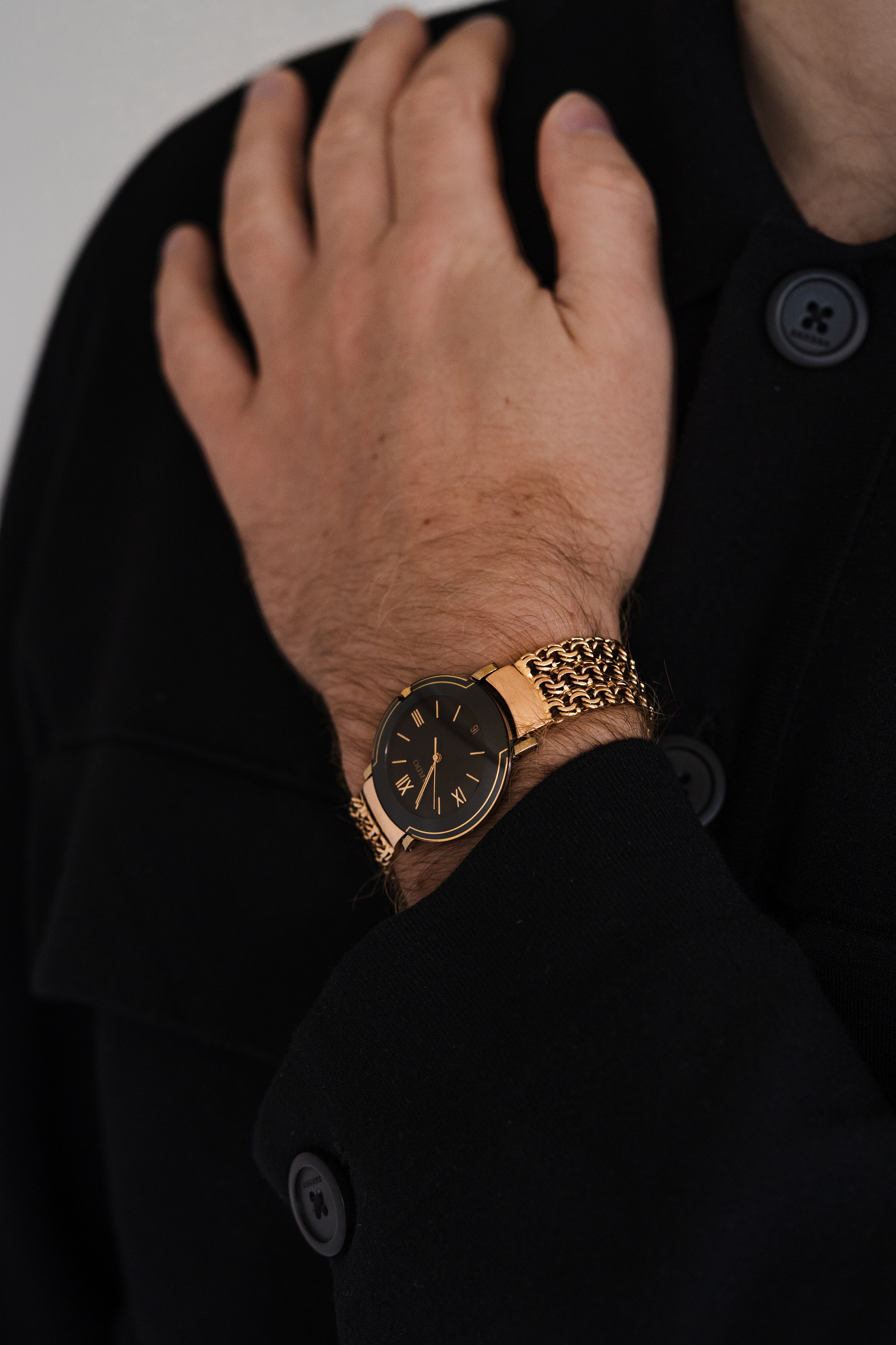 Elegant gold watch worn by gentleman - showcasing Virtuoso luxury timepiece